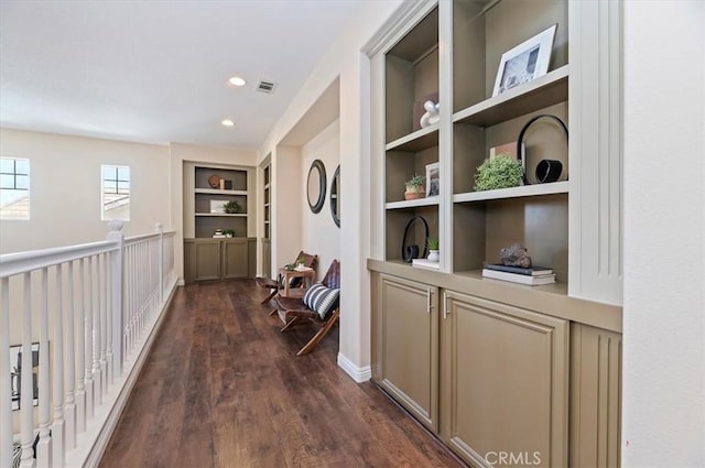 corridor featuring visible vents, dark wood finished floors, built in shelves, and recessed lighting