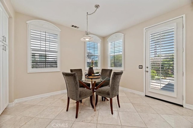dining area with light tile patterned floors, visible vents, and baseboards