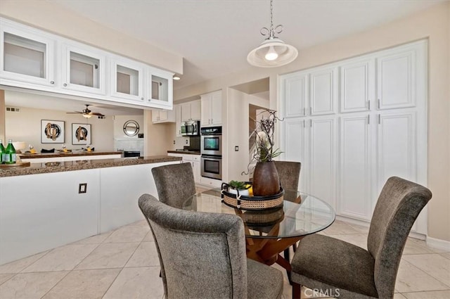 dining room featuring light tile patterned floors, ceiling fan, and visible vents