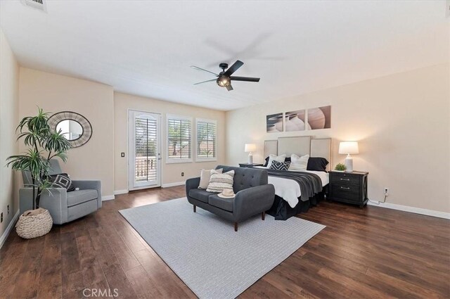bedroom featuring ceiling fan, access to outside, baseboards, and dark wood finished floors