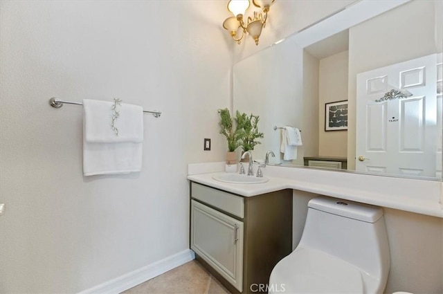 bathroom featuring tile patterned floors, toilet, vanity, and baseboards