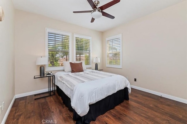 bedroom featuring baseboards, a ceiling fan, and wood finished floors
