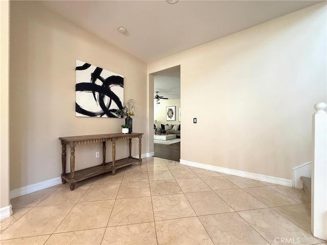 hallway featuring baseboards