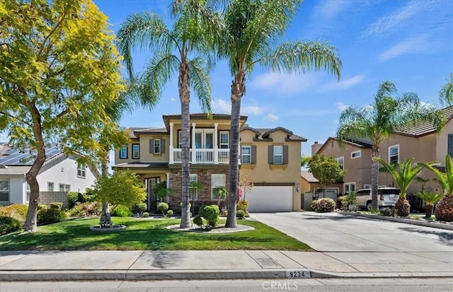 traditional home featuring stucco siding, a front yard, an attached garage, driveway, and a residential view