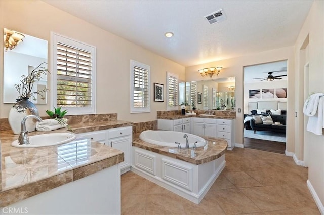 bathroom featuring tile patterned floors, a garden tub, a sink, and visible vents