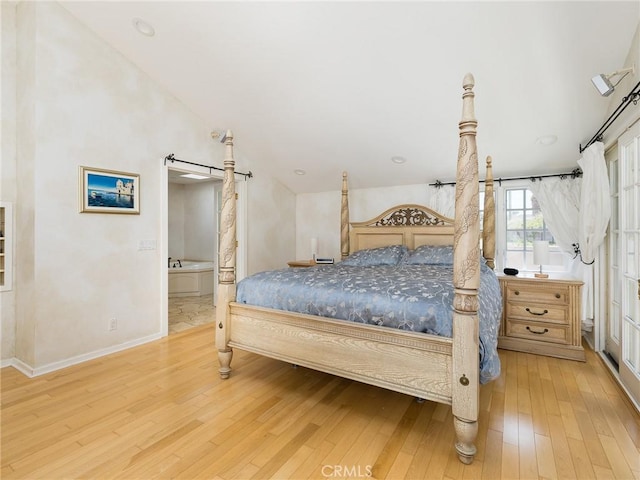 bedroom featuring wood-type flooring, baseboards, and ensuite bathroom