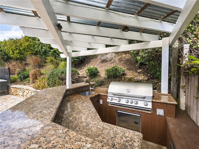 view of patio / terrace with a sink, an outdoor kitchen, a pergola, and area for grilling