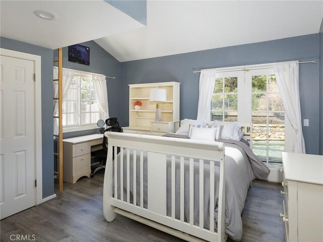 bedroom featuring wood finished floors and vaulted ceiling