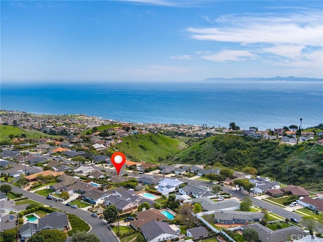 drone / aerial view featuring a water view and a residential view