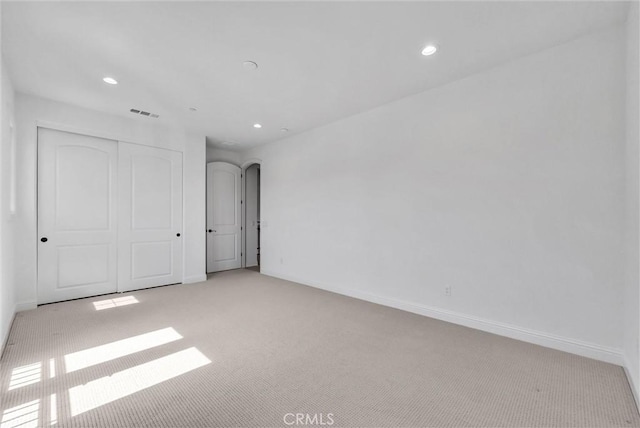 63 Poncho, Irvine, CA 92602 - unfurnished bedroom with light colored carpet, recessed lighting, a closet, and baseboards