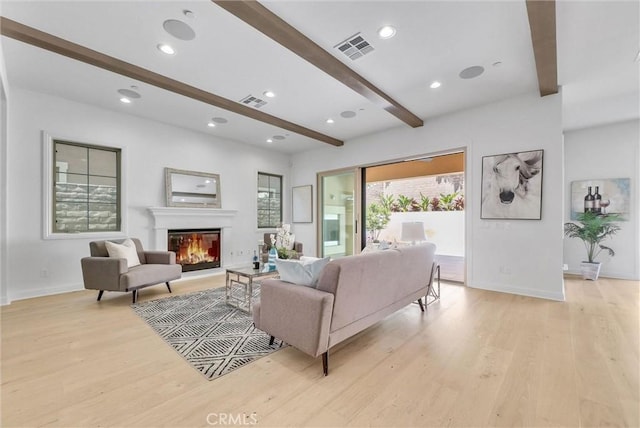 63 Poncho, Irvine, CA 92602 - living area featuring beamed ceiling, light wood-style flooring, baseboards, a glass covered fireplace, and recessed lighting