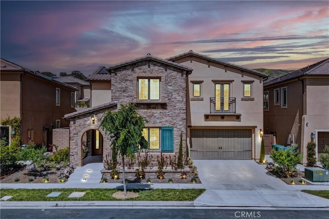 63 Poncho, Irvine, CA 92602 - view of front of property featuring stucco siding, stone siding, driveway, and a garage