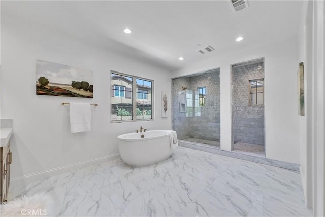 63 Poncho, Irvine, CA 92602 - full bathroom with a stall shower, a soaking tub, marble look tile flooring, baseboards, and recessed lighting