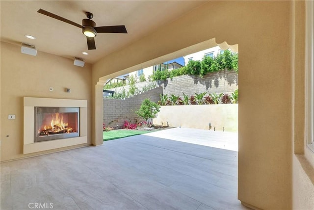 63 Poncho, Irvine, CA 92602 - view of patio / terrace with a warm lit fireplace and a ceiling fan