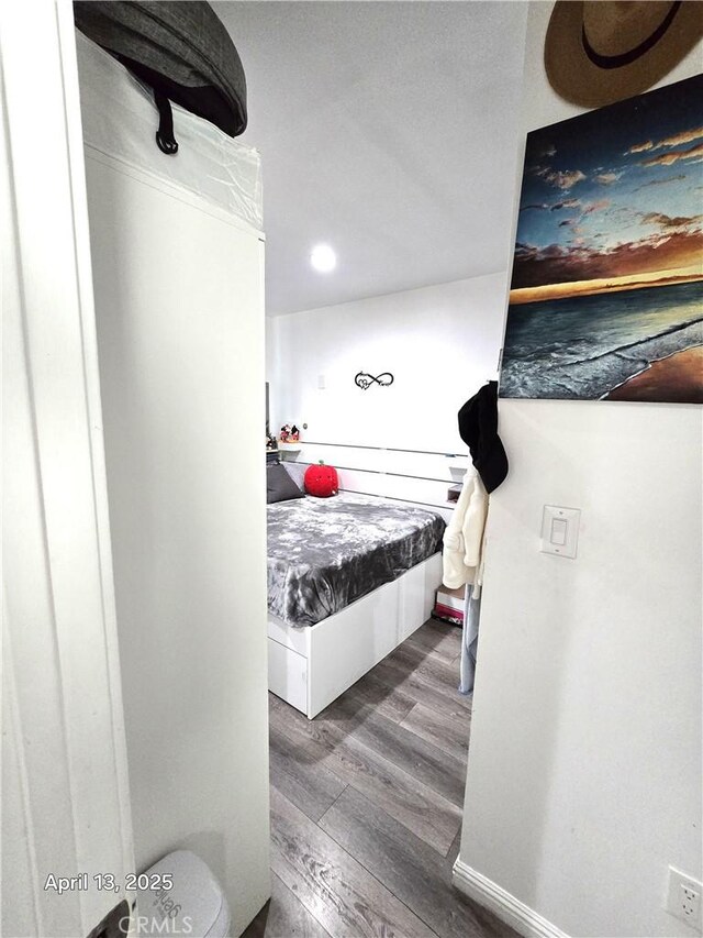 bedroom with recessed lighting and wood finished floors