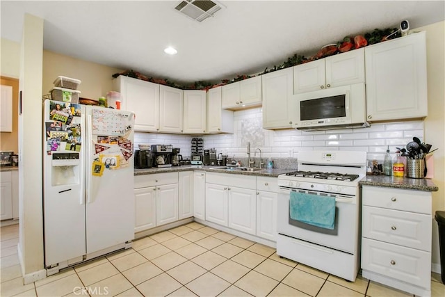 10517 50th St, Jurupa Valley, CA 91752 - kitchen featuring a sink, visible vents, white cabinetry, and white appliances