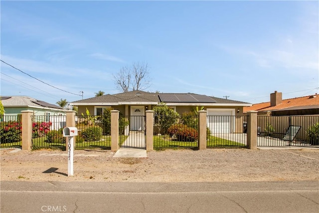 10517 50th St, Jurupa Valley, CA 91752 - view of front of property with a fenced front yard, a garage, stucco siding, a gate, and driveway