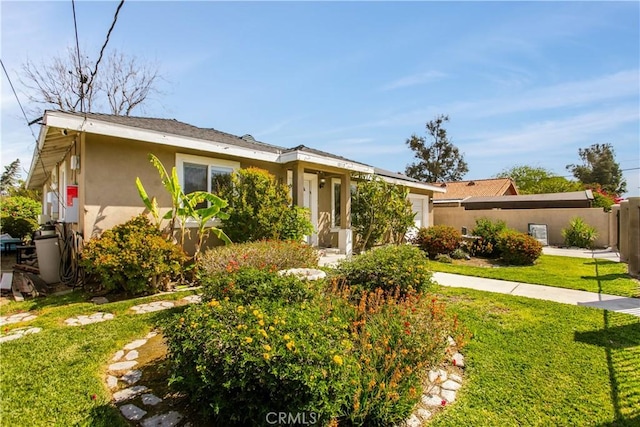 10517 50th St, Jurupa Valley, CA 91752 - ranch-style home with stucco siding, fence, an attached garage, and a front lawn