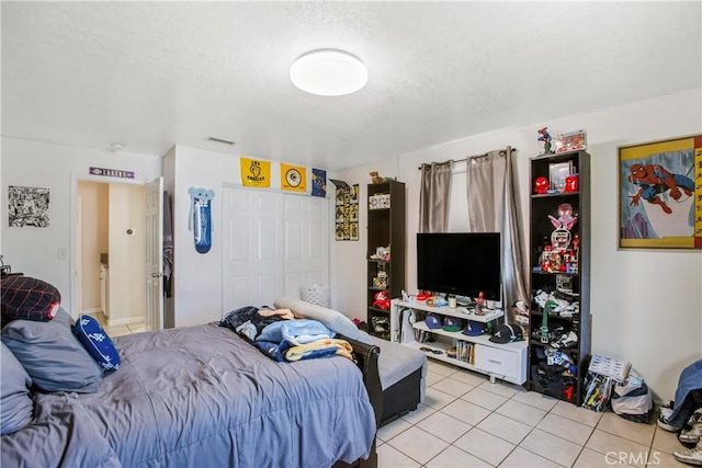 10517 50th St, Jurupa Valley, CA 91752 - bedroom with visible vents, a closet, a textured ceiling, and light tile patterned flooring