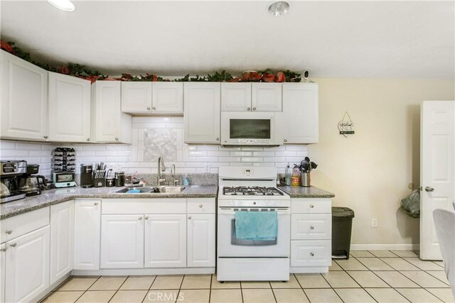 10517 50th St, Jurupa Valley, CA 91752 - kitchen featuring a sink, light tile patterned floors, decorative backsplash, and white appliances