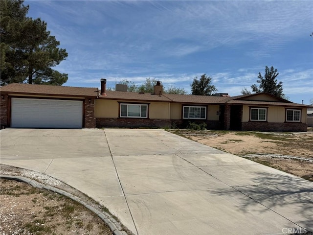 13771 Wawona Rd, Apple Valley, CA 92307 - single story home featuring a garage, driveway, and brick siding