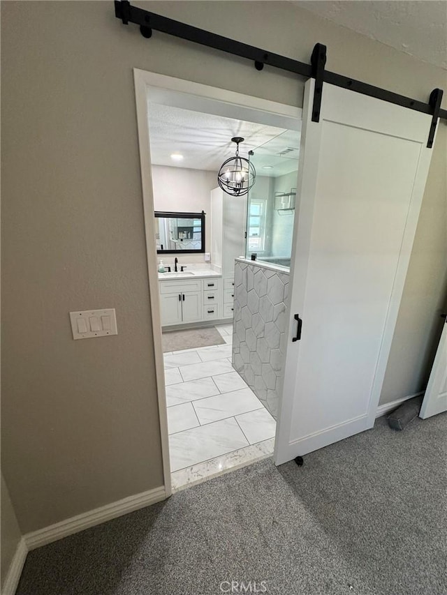 13771 Wawona Rd, Apple Valley, CA 92307 - hall featuring a barn door, light carpet, and a sink