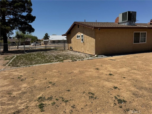 13771 Wawona Rd, Apple Valley, CA 92307 - view of side of home featuring fence, cooling unit, and stucco siding