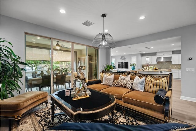 living room with light wood-style floors, ceiling fan, recessed lighting, and visible vents