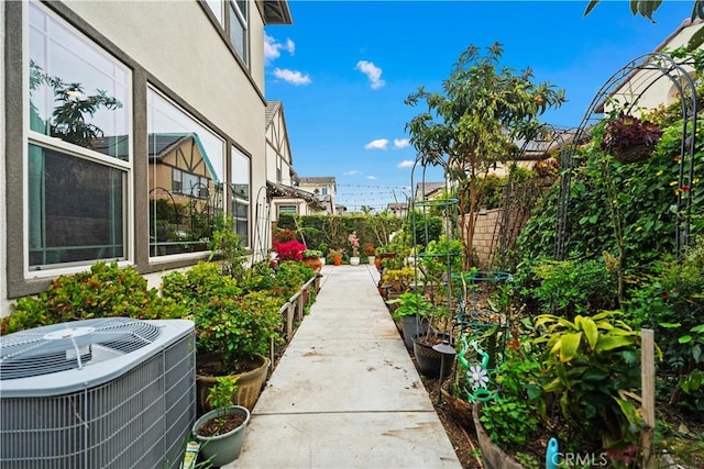 view of yard featuring central AC and fence