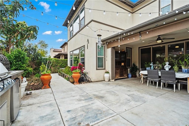 view of patio with a ceiling fan and outdoor dining area