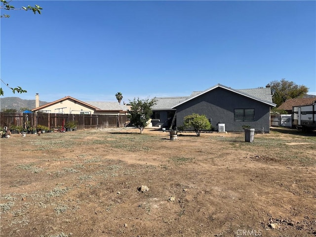view of yard featuring fence and cooling unit