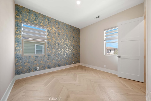 unfurnished room with baseboards, visible vents, and recessed lighting