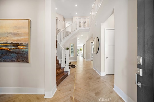 foyer with visible vents, baseboards, stairway, and recessed lighting