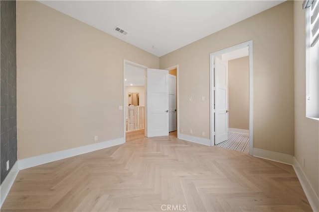 unfurnished bedroom featuring a spacious closet, visible vents, and baseboards