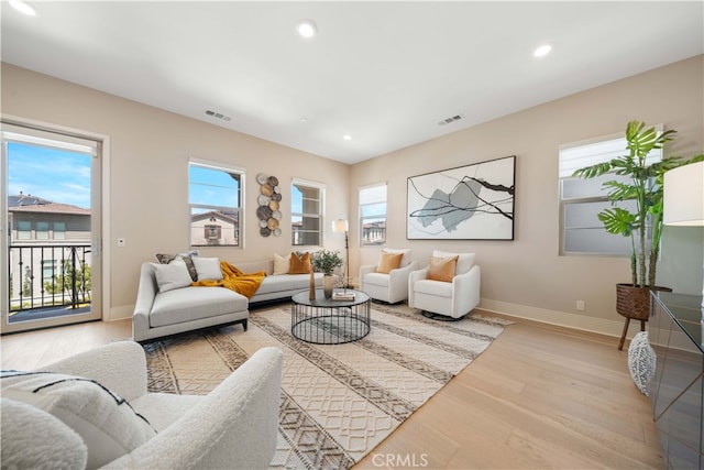 living area featuring wood finished floors, visible vents, and recessed lighting