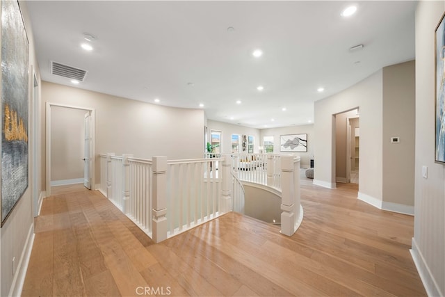 hall with visible vents, light wood-type flooring, an upstairs landing, and recessed lighting