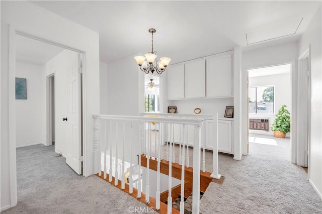 450 Anchor Way, Carlsbad, CA 92008 - hallway featuring light carpet, an upstairs landing, a chandelier, and baseboards