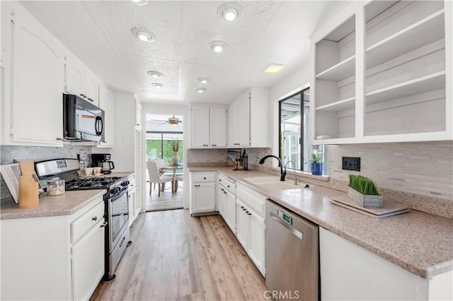 kitchen featuring a sink, tasteful backsplash, stainless steel appliances, and a wealth of natural light