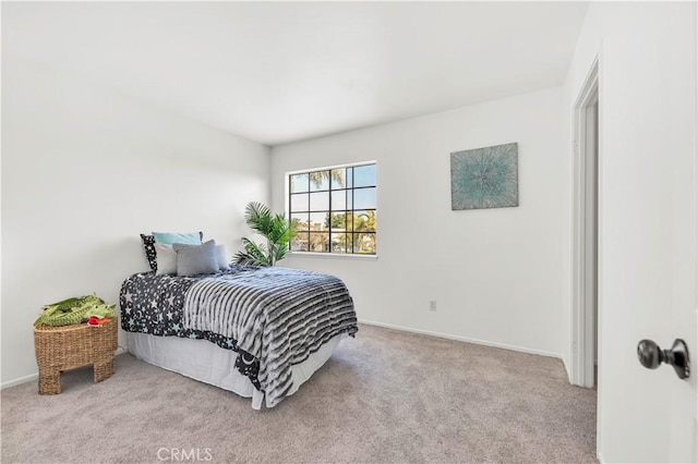 carpeted bedroom with baseboards