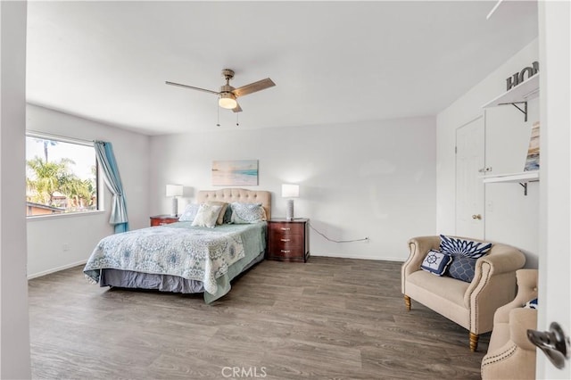 bedroom with baseboards, ceiling fan, and wood finished floors