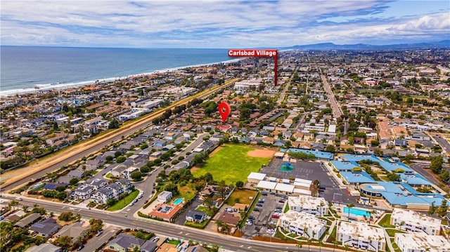drone / aerial view featuring a water and mountain view