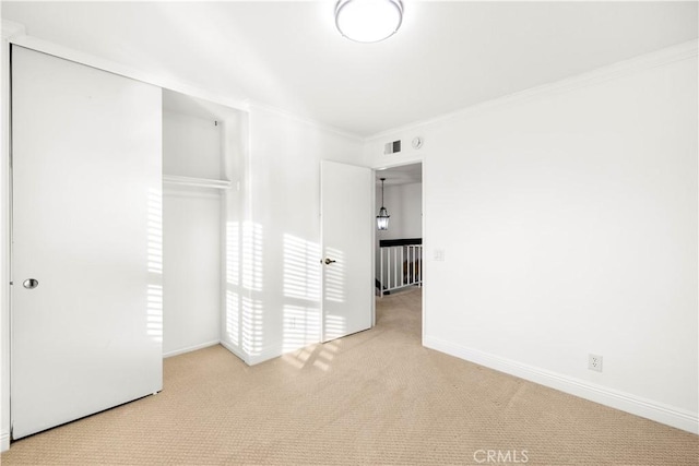 19 Alameda, Irvine, CA 92620 - unfurnished bedroom featuring a closet, carpet, baseboards, ornamental molding, and visible vents