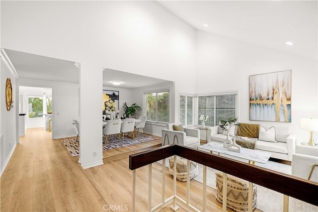 19 Alameda, Irvine, CA 92620 - living area with high vaulted ceiling, baseboards, and light wood-type flooring