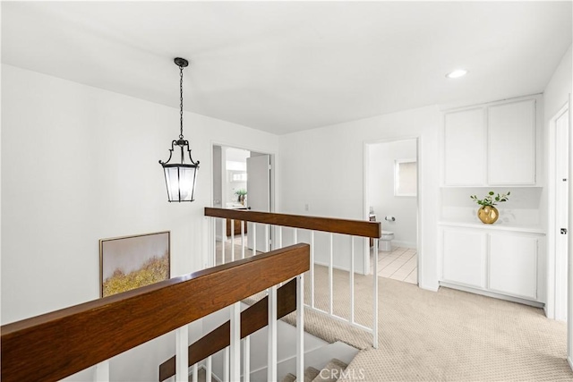 19 Alameda, Irvine, CA 92620 - corridor with light colored carpet, a chandelier, and recessed lighting