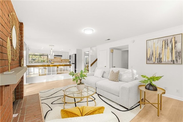 19 Alameda, Irvine, CA 92620 - living room featuring light wood-type flooring, baseboards, stairs, and visible vents