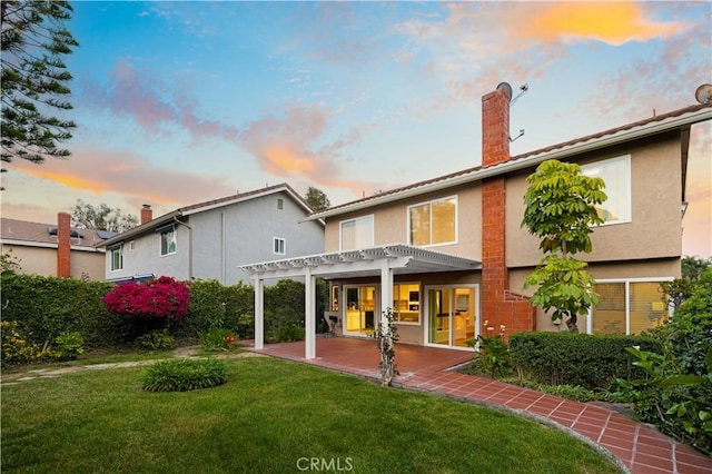 19 Alameda, Irvine, CA 92620 - back of house at dusk with a chimney, a pergola, and stucco siding