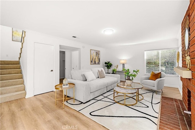 19 Alameda, Irvine, CA 92620 - living room featuring light wood-type flooring, visible vents, and stairway