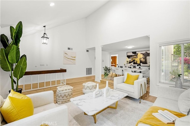 19 Alameda, Irvine, CA 92620 - living area featuring recessed lighting, wood finished floors, visible vents, baseboards, and high vaulted ceiling