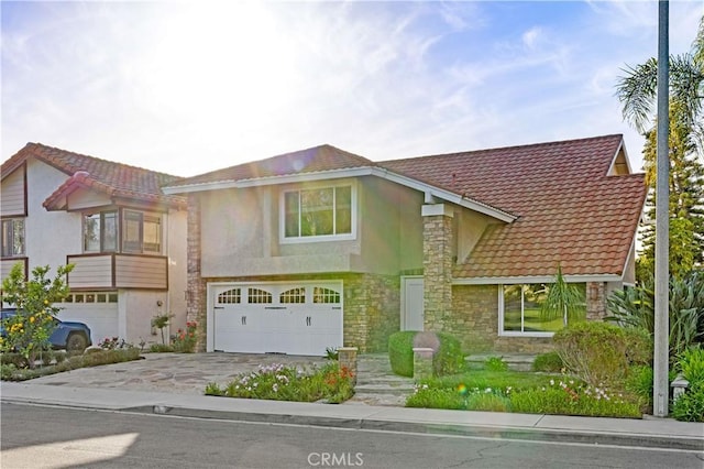 19 Alameda, Irvine, CA 92620 - view of property with a garage, driveway, stone siding, and stucco siding