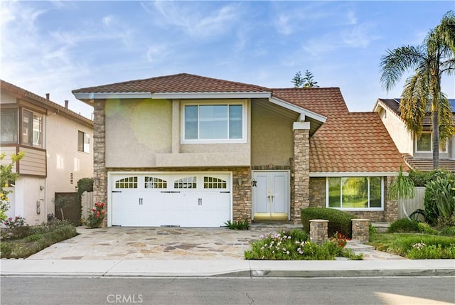 19 Alameda, Irvine, CA 92620 - traditional-style home with concrete driveway, an attached garage, a tile roof, stucco siding, and stone siding